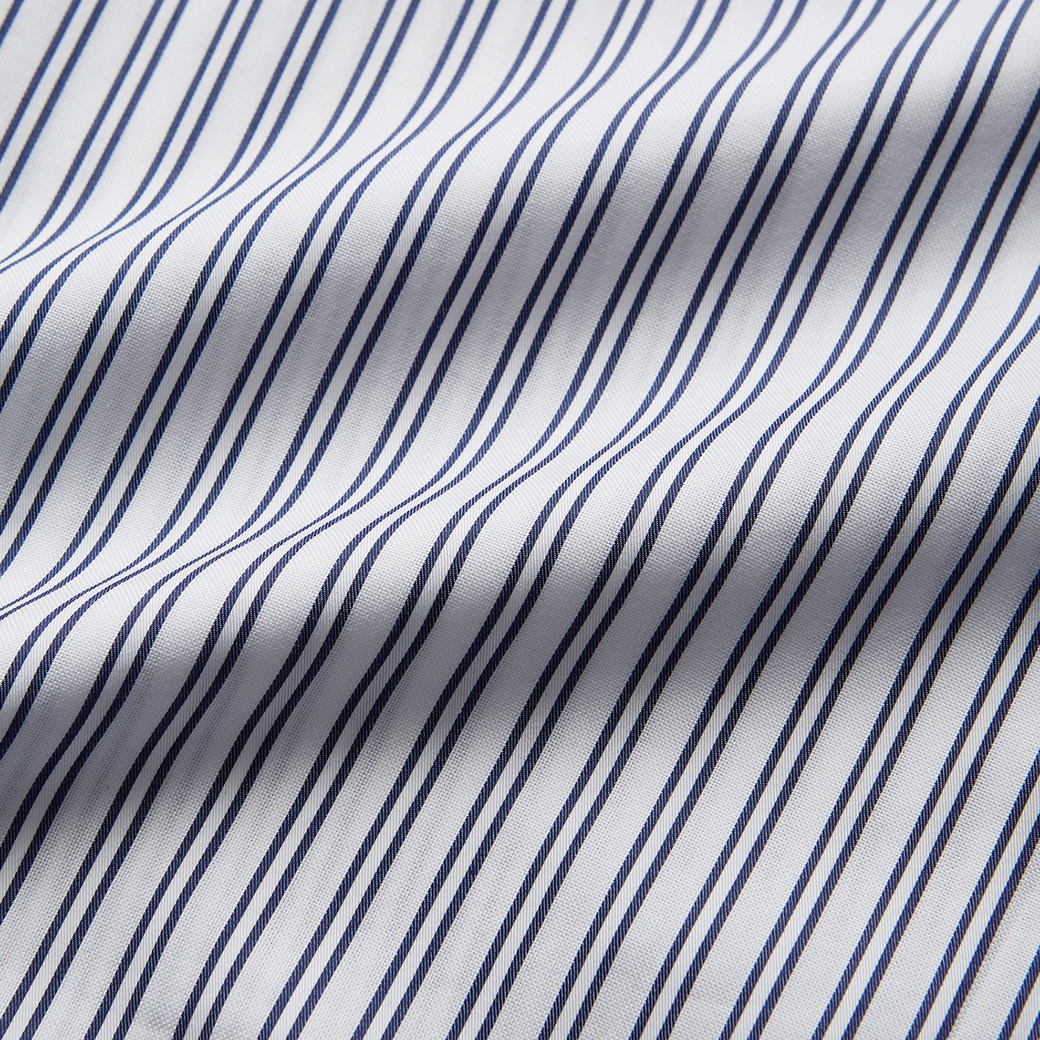 View 4 of product The Turnbull & Asser White and Navy Striped Cotton Sussex Nightshirt features long sleeves, a knee-length cut, a collar, front buttons, a chest pocket with dark trim, and a curved hem for modern comfort inspired by tradition.