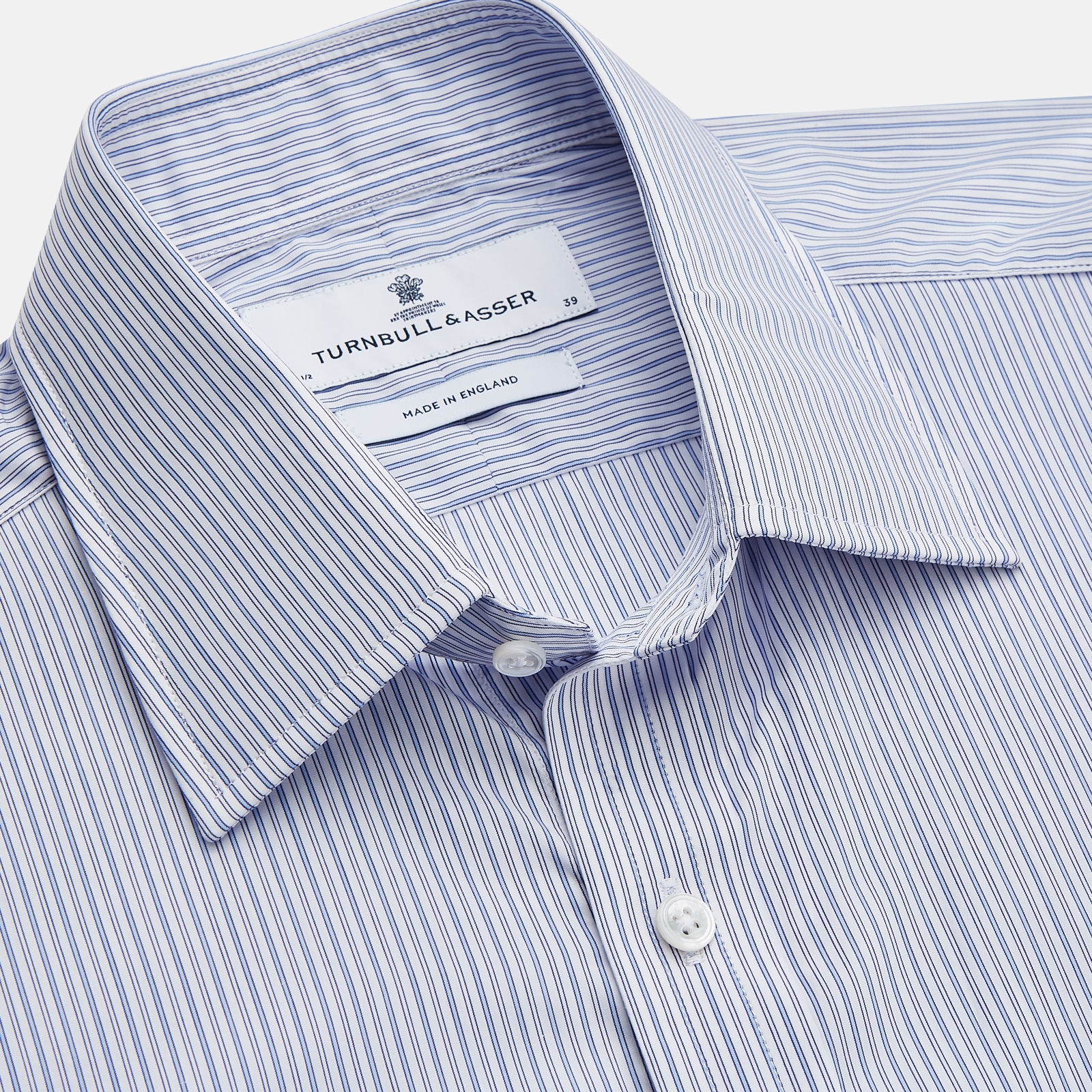 View 2 of product The Turnbull & Asser Blue Multi Stripe Cotton Regular Fit Whitby Shirt features long sleeves, a classic collar, button-down front, and double cuffs, shown laid flat on a white background.