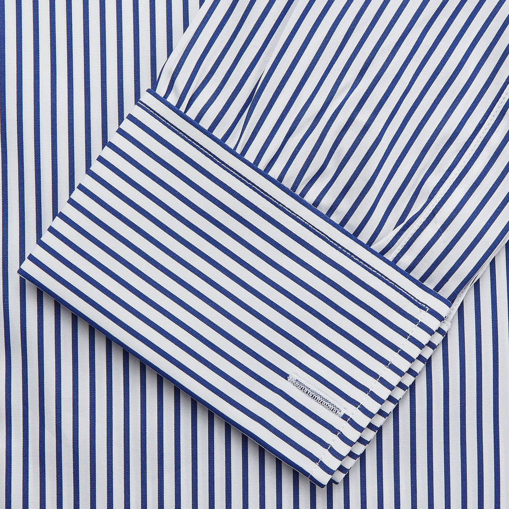 The Turnbull & Asser Navy Stripe Cotton Regular Fit Whitby Shirt features vertical blue and white stripes, long sleeves, a collar, double cuffs, and a button-down front, shown laid flat on a white background.