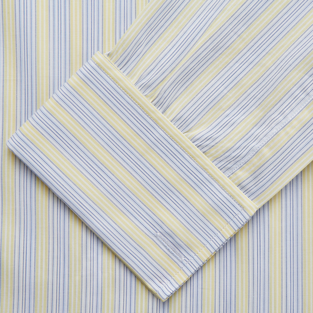 The Yellow and Pale Blue Multi Stripe Cotton Regular Fit Whitby Shirt by Turnbull & Asser features light blue and yellow stripes on white, a classic collar, white buttons, long sleeves, and wide double cuffs.