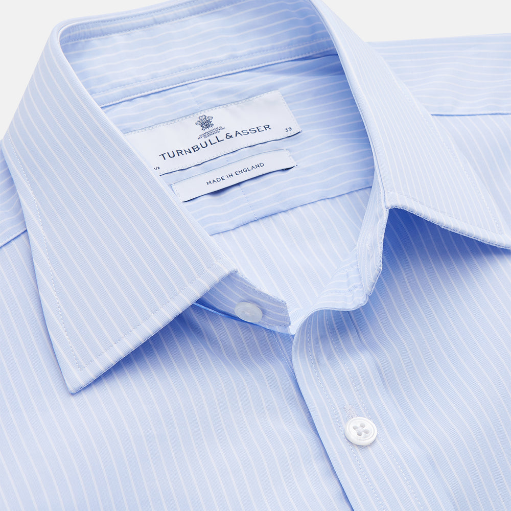The Light Blue Multi-stripe Cotton Regular Fit Mayfair Shirt by Turnbull & Asser features a T&A collar, button-down front, and buttoned cuffs, displayed flat against a white background.