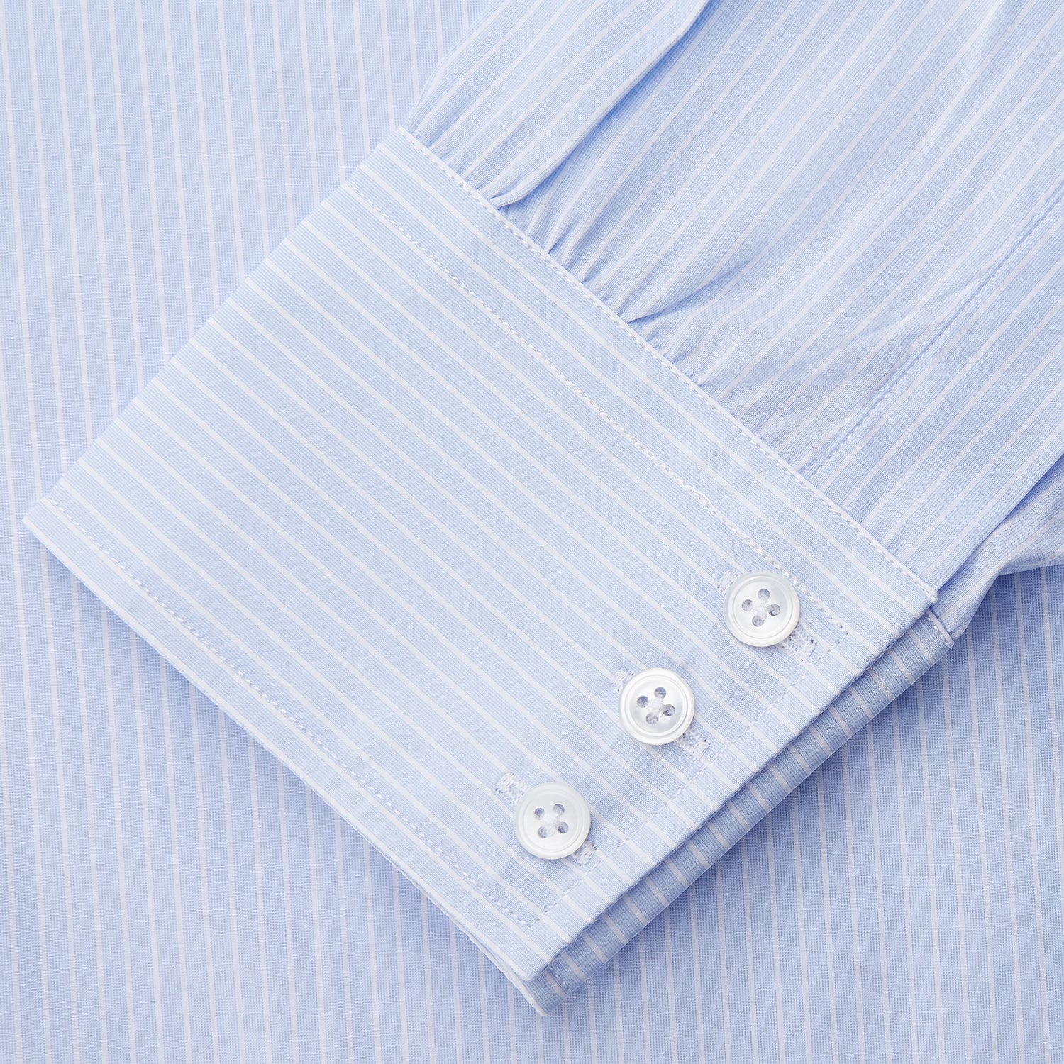View 3 of product The Light Blue Multi-stripe Cotton Regular Fit Mayfair Shirt by Turnbull & Asser features a T&A collar, button-down front, and buttoned cuffs, displayed flat against a white background.