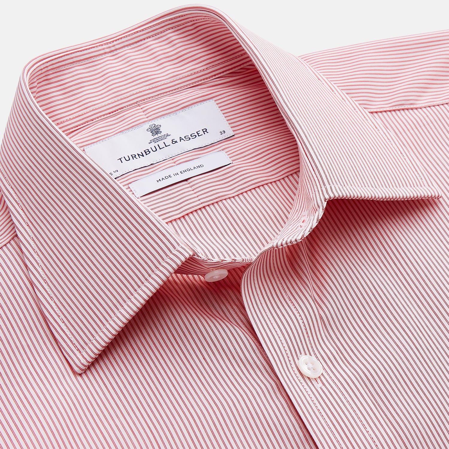 View 2 of product The Turnbull & Asser Pink and White Stripe Cotton Regular Fit Mayfair Shirt features a T&A collar, long sleeves, and white buttons, shown against a plain white background.