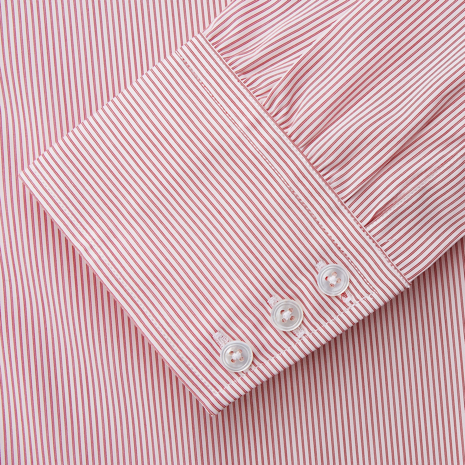 View 3 of product The Turnbull & Asser Pink and White Stripe Cotton Regular Fit Mayfair Shirt features a T&A collar, long sleeves, and white buttons, shown against a plain white background.