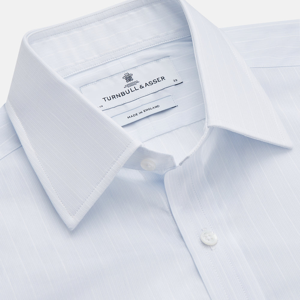 A Cloudy Blue Stripe Cotton Regular Fit Mayfair Shirt by Turnbull & Asser, featuring a T&A collar and button-down front, is laid flat on a plain white background.