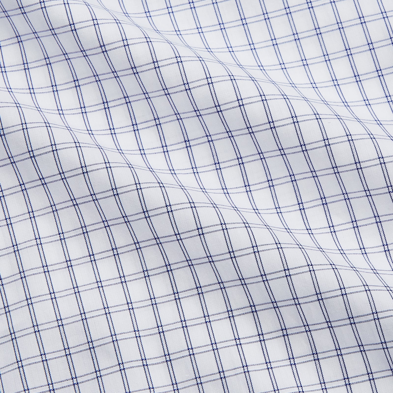 View 4 of product The Turnbull & Asser White and Blue Check Cotton Regular Fit Mayfair Shirt features a classic button-up design with long sleeves, traditional collar and cuffs, displayed flat against a white background.