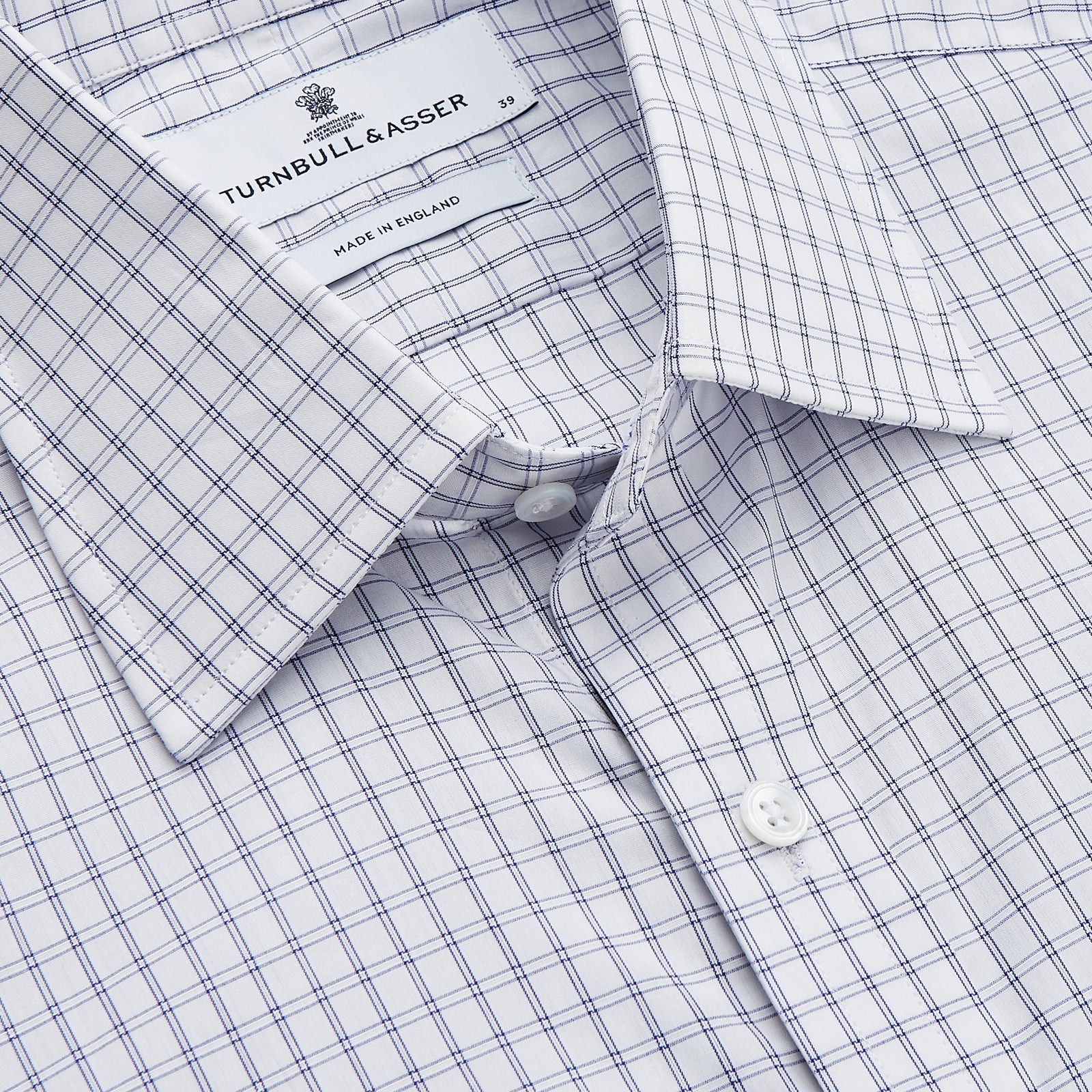 View 2 of product The Turnbull & Asser White and Blue Check Cotton Regular Fit Mayfair Shirt features a classic button-up design with long sleeves, traditional collar and cuffs, displayed flat against a white background.