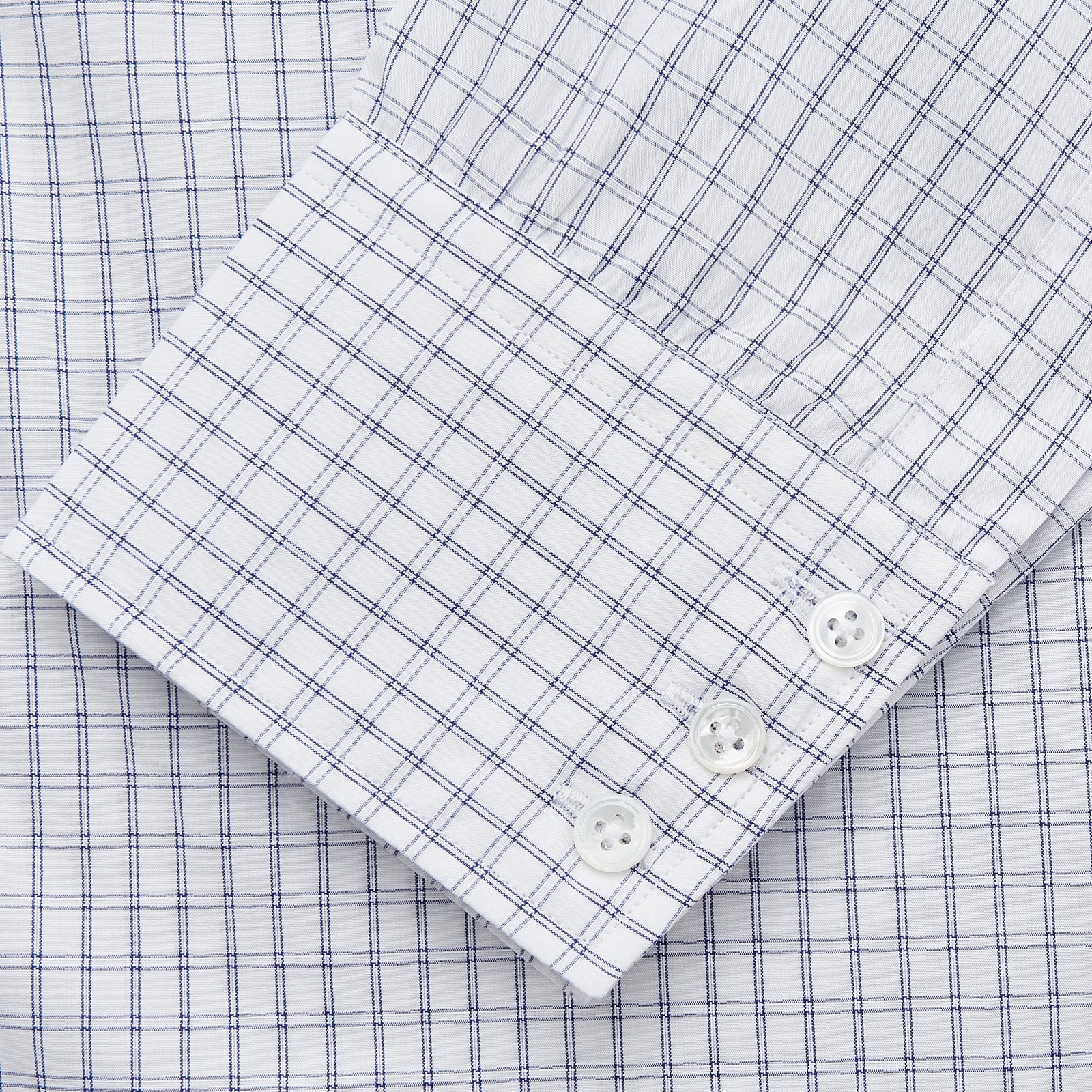 View 3 of product The Turnbull & Asser White and Blue Check Cotton Regular Fit Mayfair Shirt features a classic button-up design with long sleeves, traditional collar and cuffs, displayed flat against a white background.