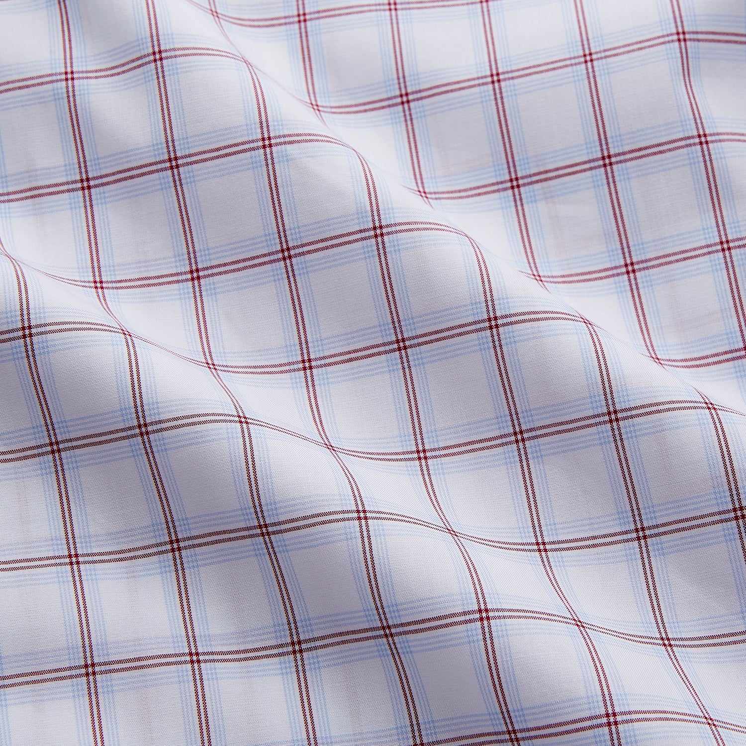 View 4 of product The Turnbull & Asser Red and Blue Multi-check Cotton Regular Fit Mayfair Shirt features a white base with red and blue checks, long sleeves, a T&A collar, and is shown flat against a white surface.