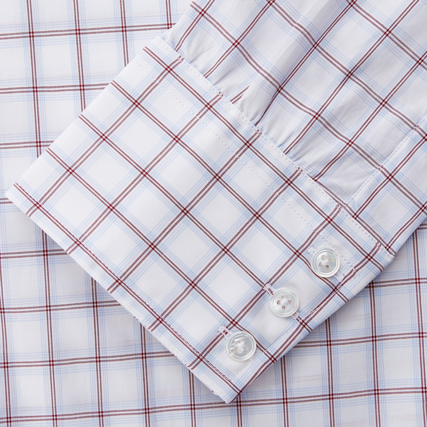 View 3 of product The Turnbull & Asser Red and Blue Multi-check Cotton Regular Fit Mayfair Shirt features a white base with red and blue checks, long sleeves, a T&A collar, and is shown flat against a white surface.