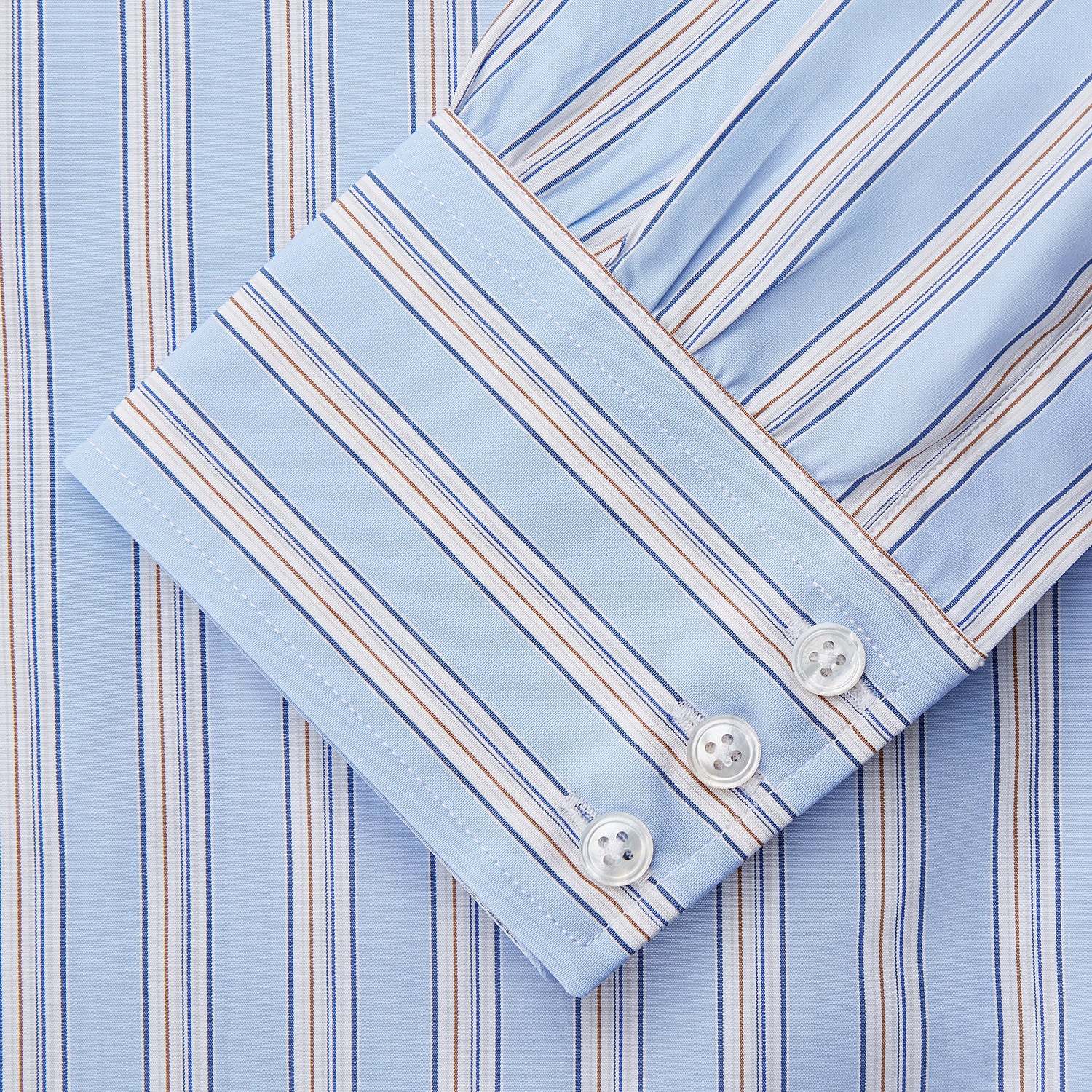 View 3 of product The Turnbull & Asser Pale Blue Multi-stripe Cotton Regular Fit Mayfair Shirt, featuring long sleeves, buttoned cuffs, and a signature T&A collar, is laid flat on a white background.