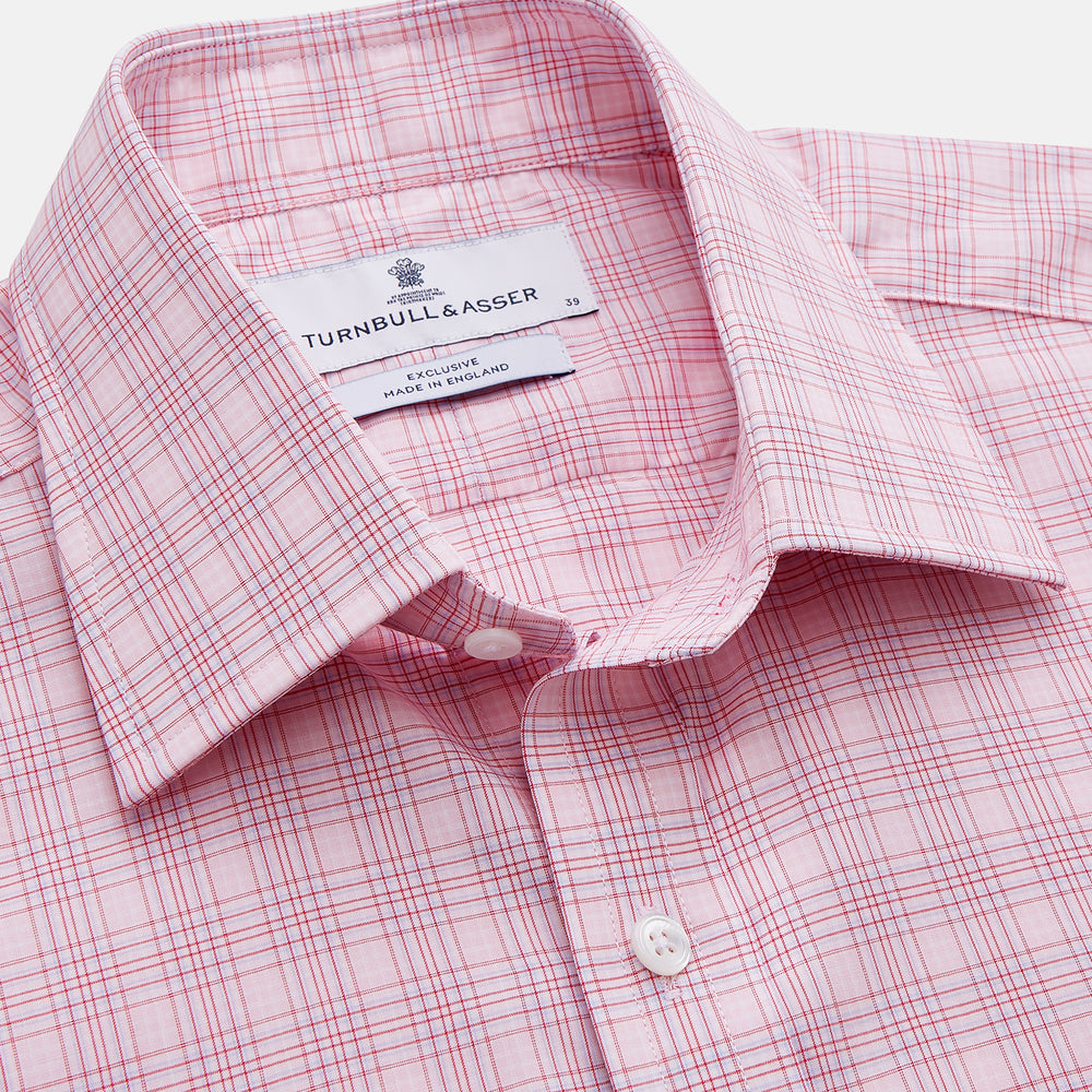 The Turnbull & Asser Pink Multi-check Cotton Regular Fit Mayfair Shirt features long sleeves, a T&A collar, buttoned cuffs, and a light pink check pattern, shown against a plain white background.