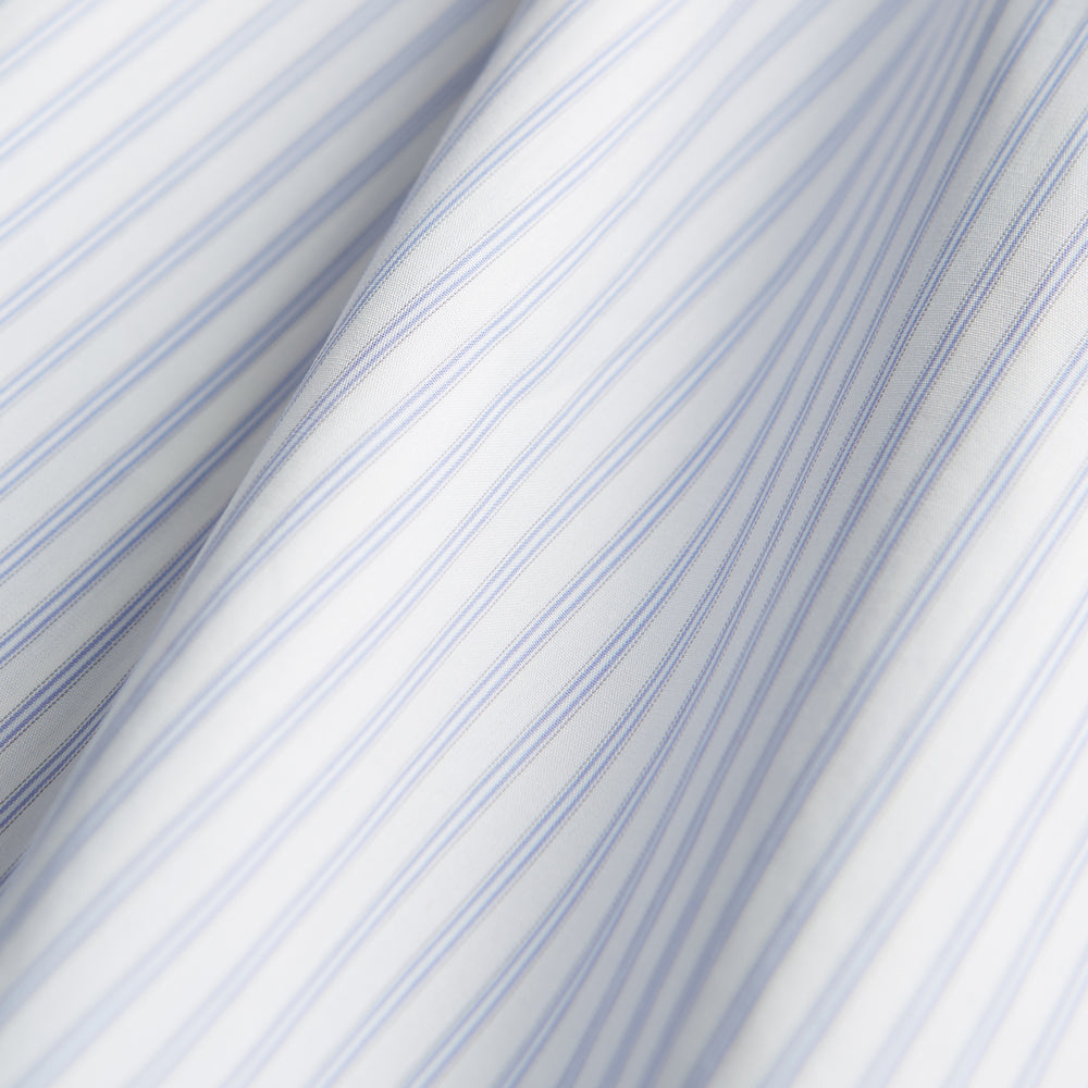 The Turnbull & Asser Pale Blue and White Multi-stripe Cotton Regular Fit Mayfair Shirt features a T&A collar and buttoned cuffs, shown on a plain white background.