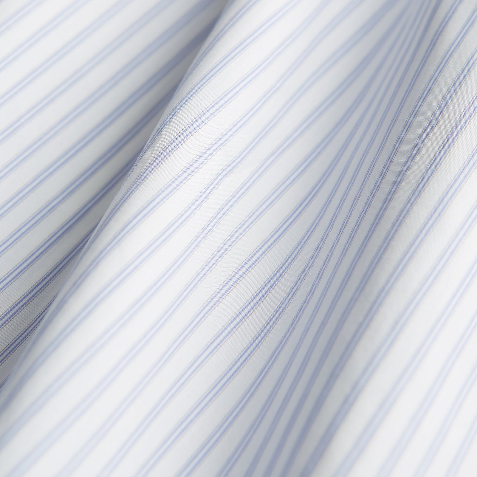 View 4 of product The Turnbull & Asser Pale Blue and White Multi-stripe Cotton Regular Fit Mayfair Shirt features a T&A collar and buttoned cuffs, shown on a plain white background.