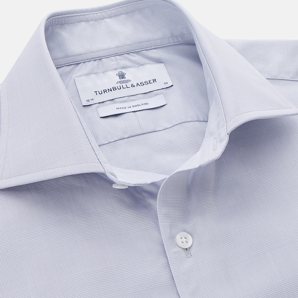 The Turnbull & Asser Faded Blue Block Check Cotton Shelton Shirt features a tailored fit, long sleeves, button-down front, and classic collar, displayed flat on a white background.