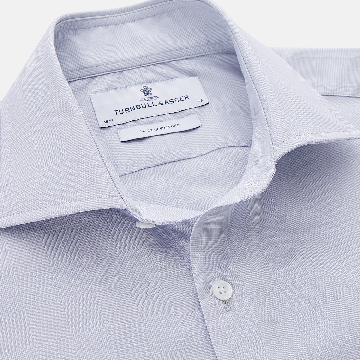 View 2 of product The Turnbull & Asser Faded Blue Block Check Cotton Shelton Shirt features a tailored fit, long sleeves, button-down front, and classic collar, displayed flat on a white background.