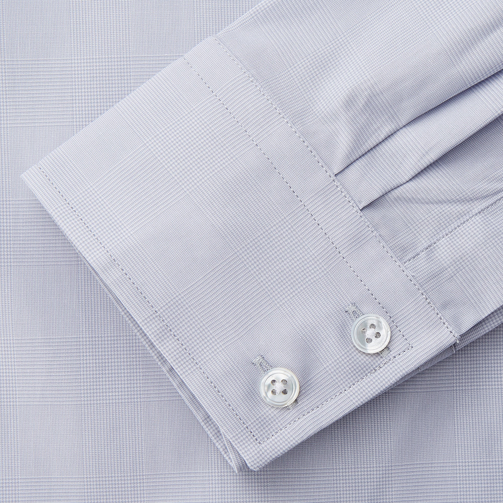 The Turnbull & Asser Faded Blue Block Check Cotton Shelton Shirt features a tailored fit, long sleeves, button-down front, and classic collar, displayed flat on a white background.