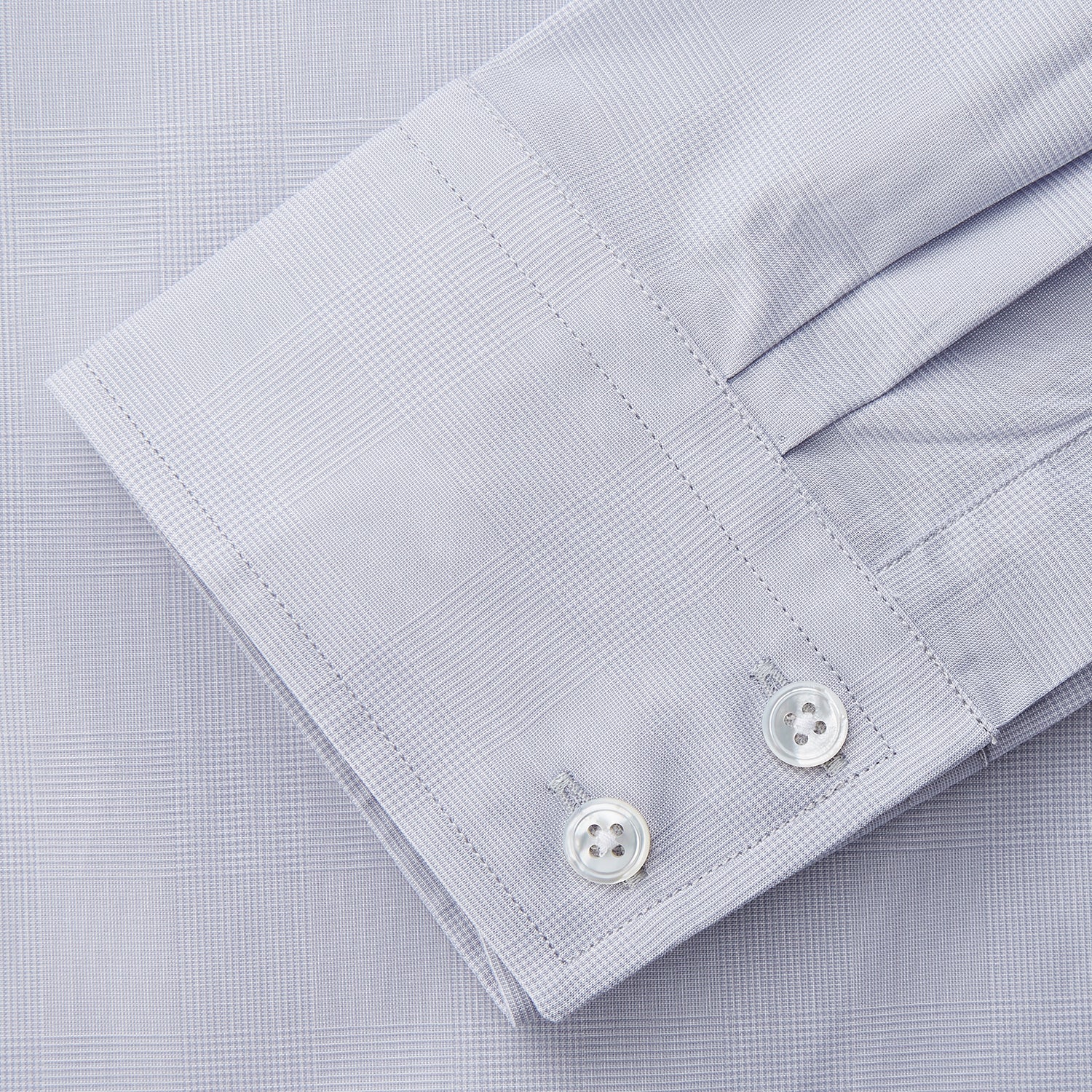 View 3 of product The Turnbull & Asser Faded Blue Block Check Cotton Shelton Shirt features a tailored fit, long sleeves, button-down front, and classic collar, displayed flat on a white background.