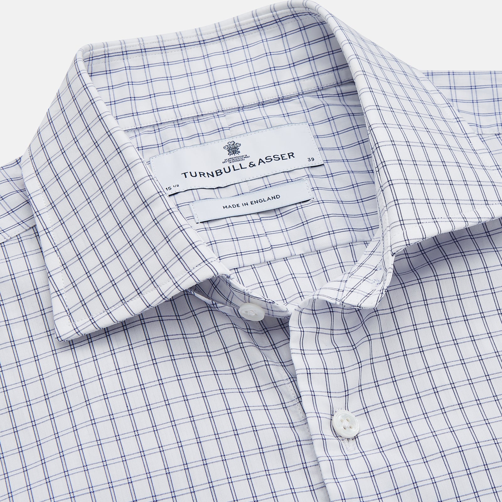 View 2 of product The Turnbull & Asser White and Blue Check Cotton Tailored Fit Shelton Shirt, a men's button-up dress shirt, is shown laid flat on a white background.