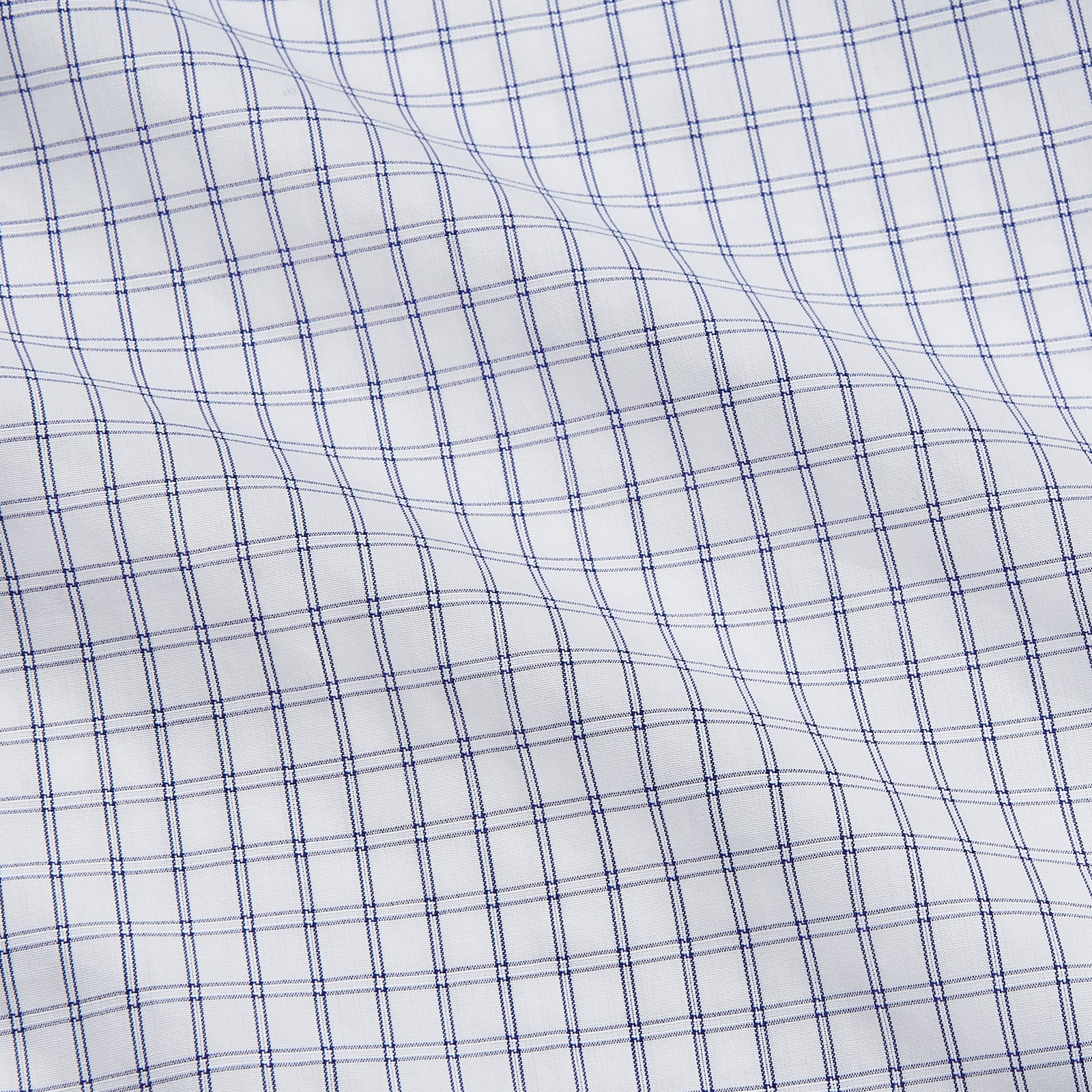 View 4 of product The Turnbull & Asser White and Blue Check Cotton Tailored Fit Shelton Shirt, a men's button-up dress shirt, is shown laid flat on a white background.
