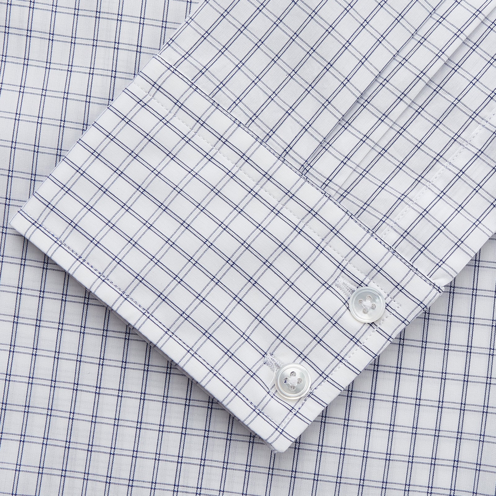 View 3 of product The Turnbull & Asser White and Blue Check Cotton Tailored Fit Shelton Shirt, a men's button-up dress shirt, is shown laid flat on a white background.