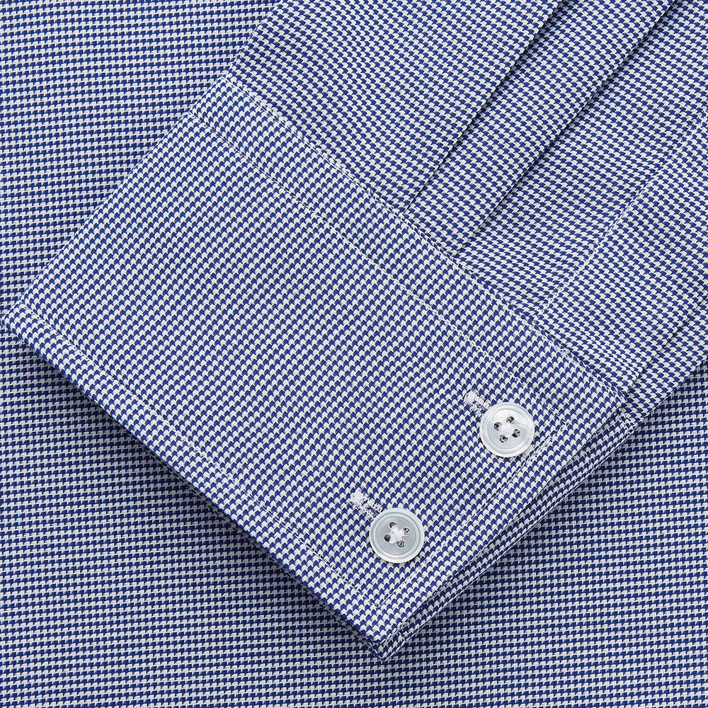 The Turnbull & Asser Navy Pattern Cotton Voile Tailored Fit Shelton Shirt is laid flat, showcasing its classic collar and white front and cuff buttons.