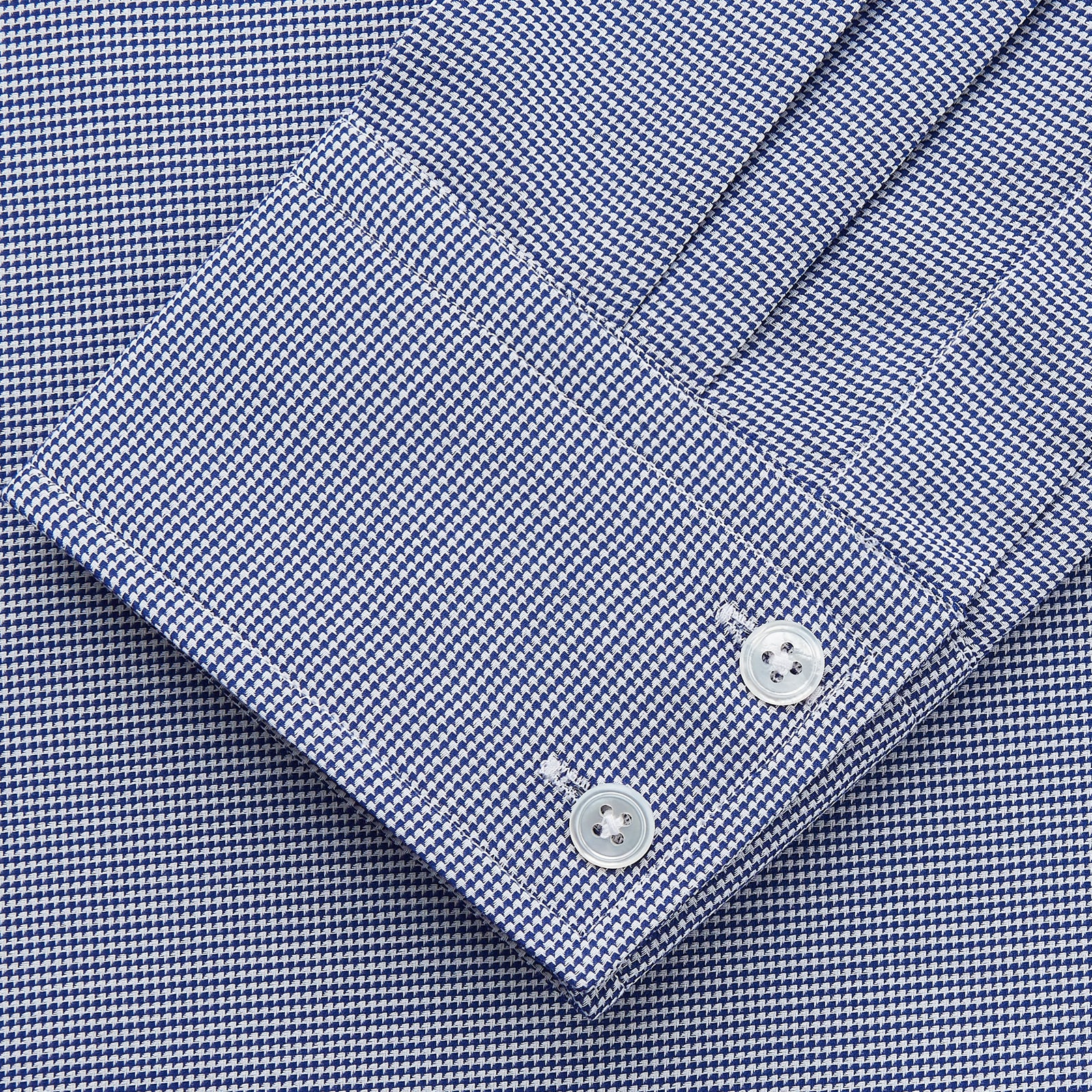 View 3 of product The Turnbull & Asser Navy Pattern Cotton Voile Tailored Fit Shelton Shirt is laid flat, showcasing its classic collar and white front and cuff buttons.