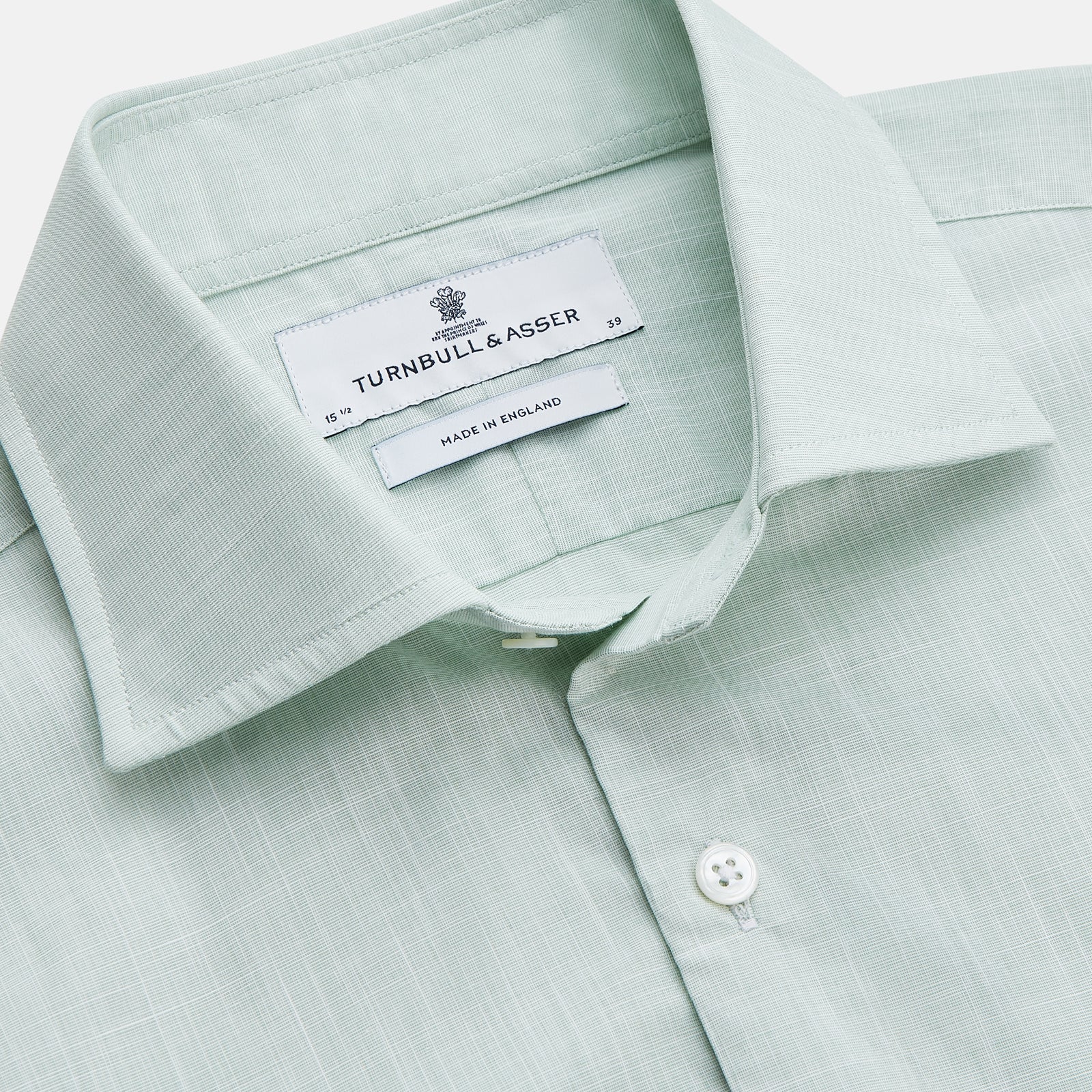 View 2 of product The Turnbull & Asser Light Green Chambray Tailored Fit Shelton Shirt features long sleeves, a classic collar, and white buttons—an elegant men's formal shirt shown neatly laid flat on a white background.