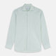 The Turnbull & Asser Light Green Chambray Tailored Fit Shelton Shirt features long sleeves, a classic collar, and white buttons—an elegant men's formal shirt shown neatly laid flat on a white background.
