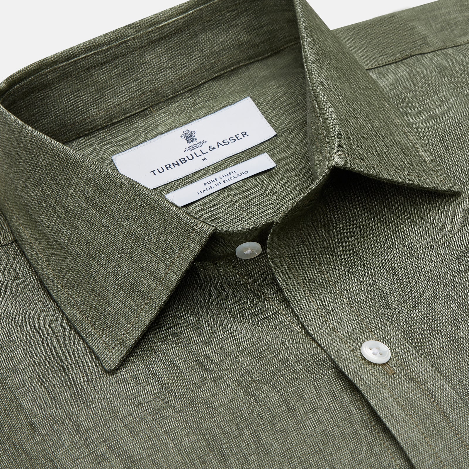 View 3 of product The Sage Green Linen Weekend Fit Finch Shirt by Turnbull & Asser features a classic collar, white buttons, and a single chest pocket—an essential piece for any men's wardrobe. Displayed flat on a white background for a clean look.