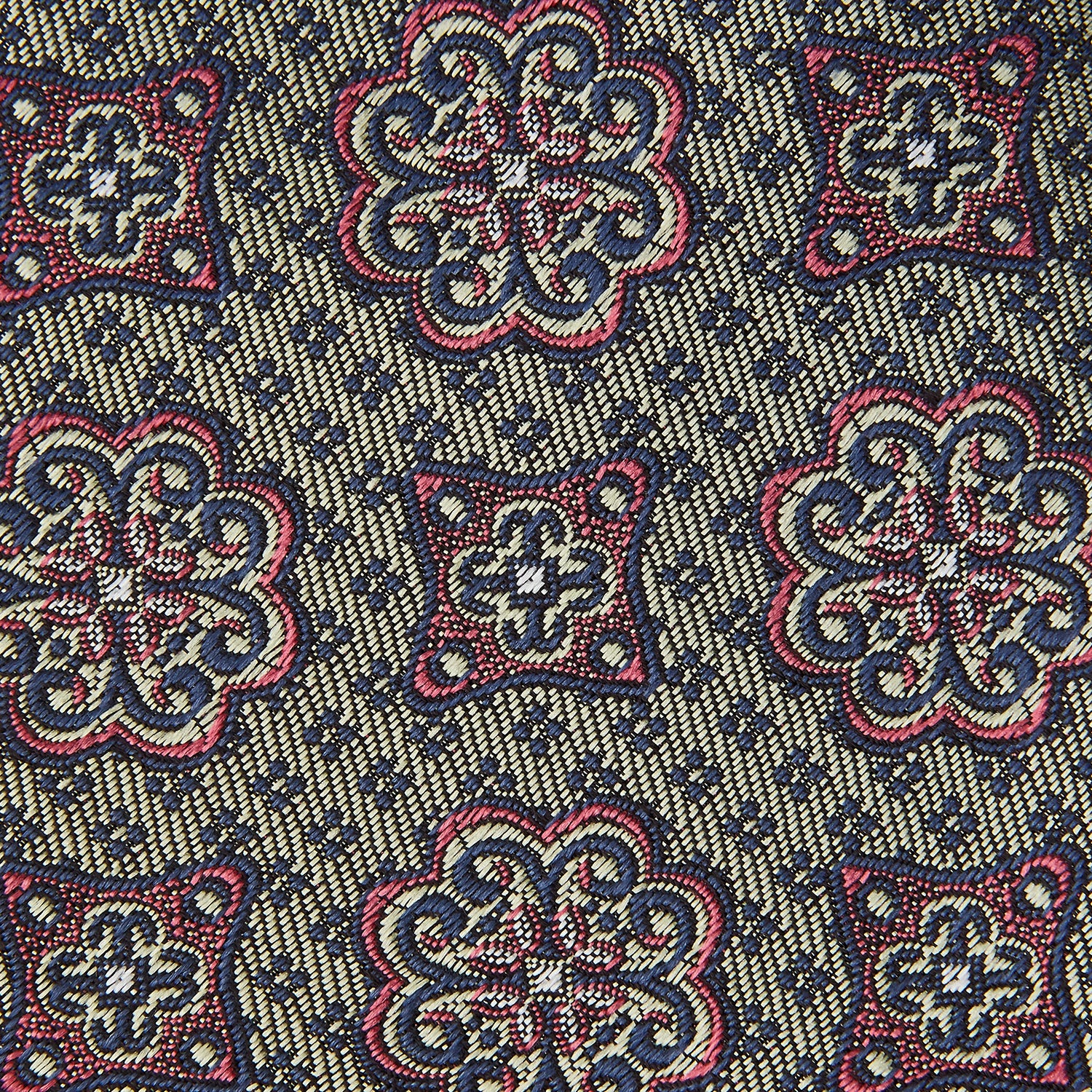View 3 of product The Green Floral Tile Silk Tie by Turnbull & Asser features a gold background with a repeating green floral pattern in red, navy blue, and cream, showcasing classic style and an evenly distributed silk texture throughout.