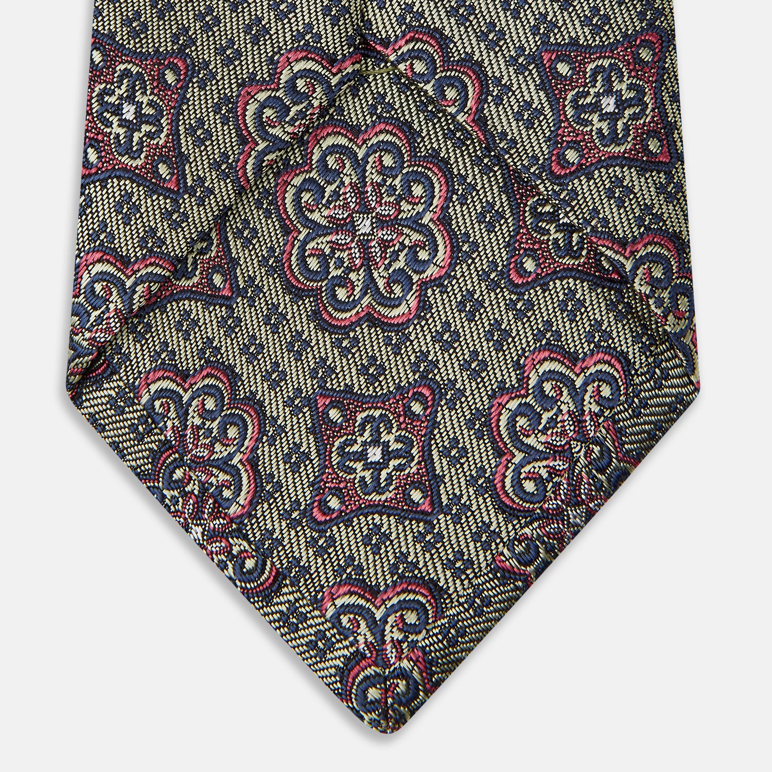 View 4 of product The Green Floral Tile Silk Tie by Turnbull & Asser features a gold background with a repeating green floral pattern in red, navy blue, and cream, showcasing classic style and an evenly distributed silk texture throughout.