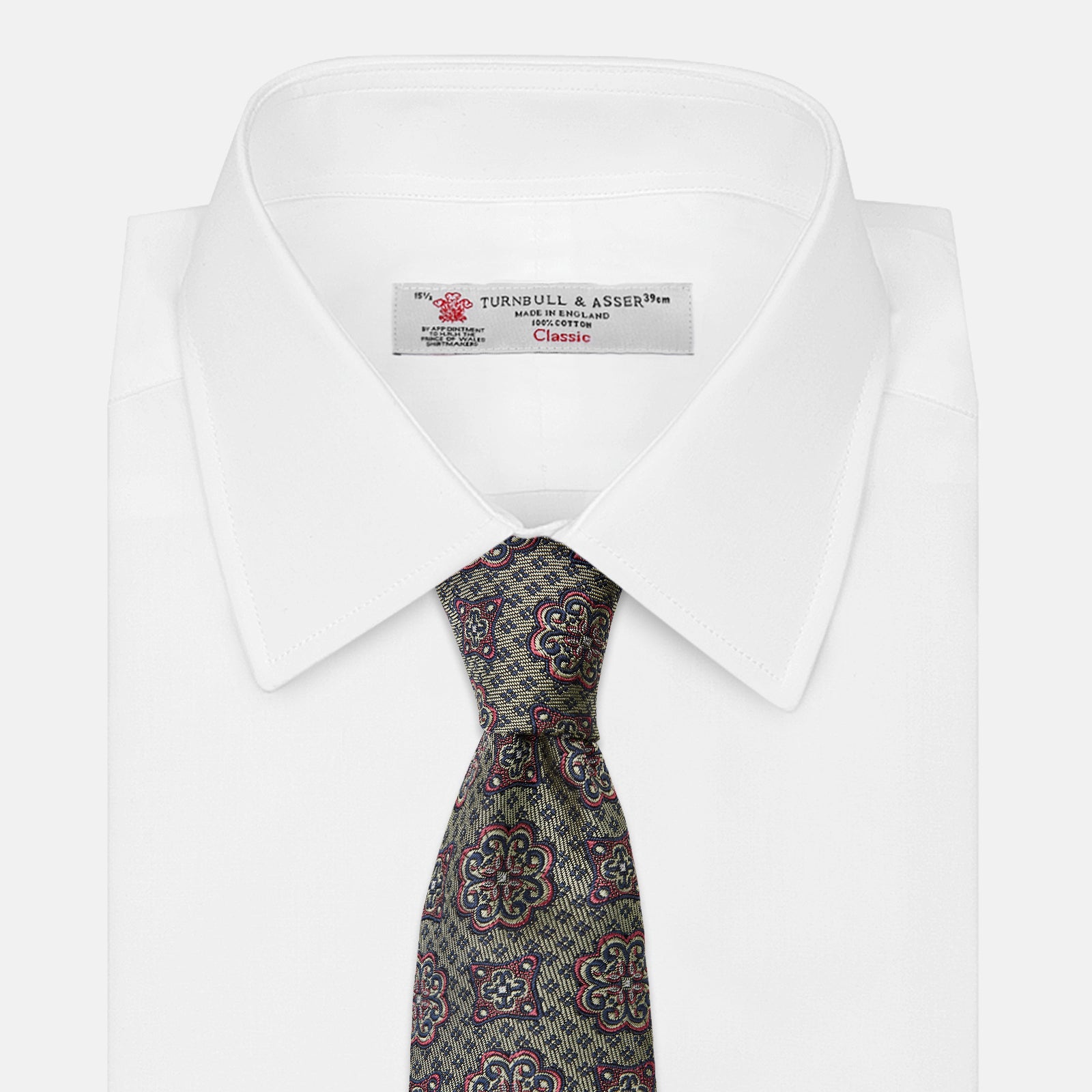 View 2 of product The Green Floral Tile Silk Tie by Turnbull & Asser features a gold background with a repeating green floral pattern in red, navy blue, and cream, showcasing classic style and an evenly distributed silk texture throughout.
