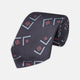 A Turnbull & Asser Navy Graphic Deco Silk Tie, featuring light blue chevrons and red squares on a dark navy background, shown rolled up against a plain white backdrop.