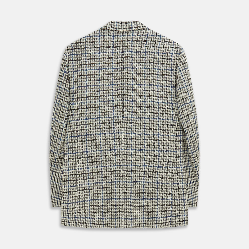 The Grey and Navy Tweed Barrington Blazer by Turnbull & Asser is a single-breasted jacket with notched lapels, two front buttons, flap pockets, and a tailored fit—expertly made in Italy for sophisticated style.