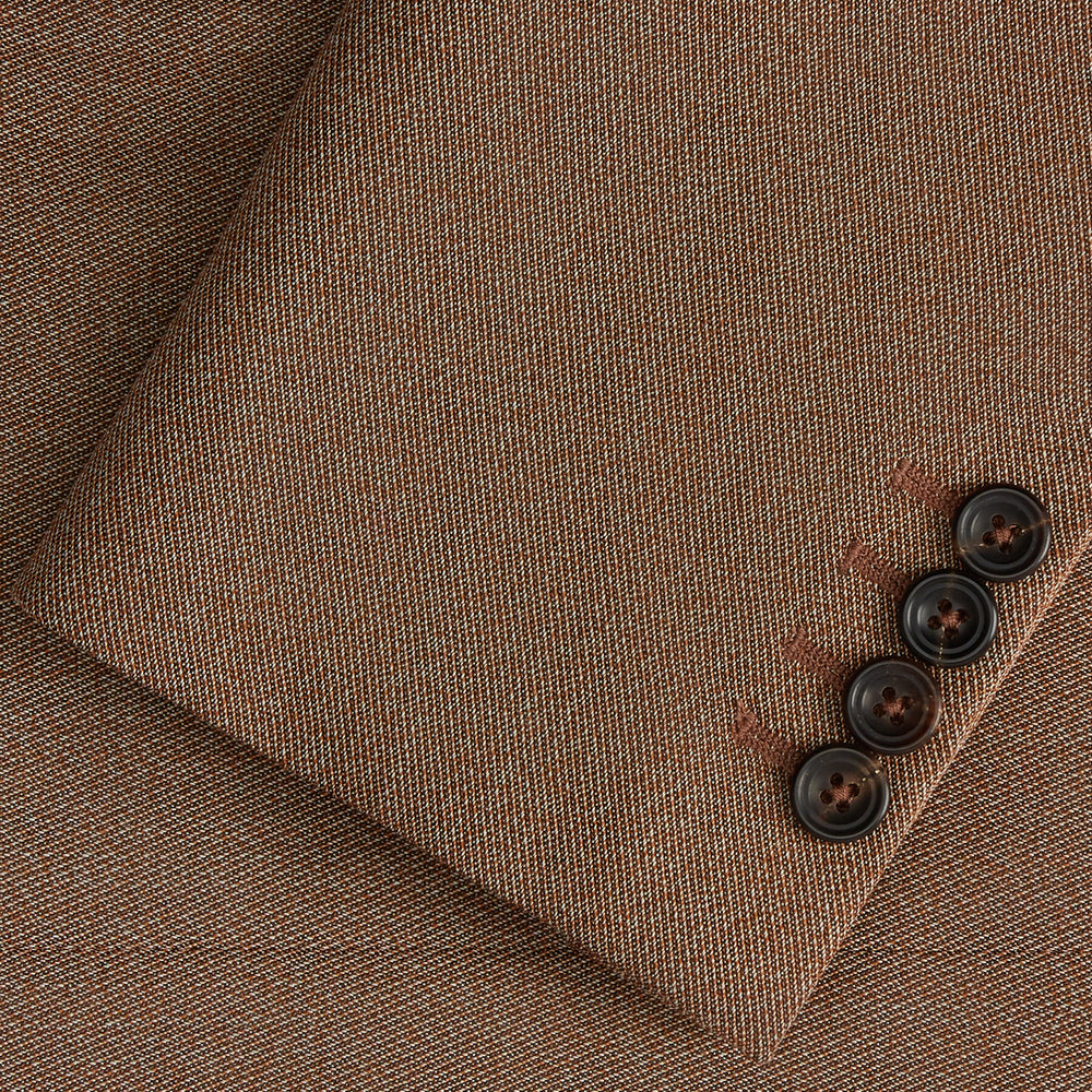 The Brown Virgin Wool Bern Blazer by Turnbull & Asser features notch lapels, two front patch pockets, a chest pocket, buttoned cuffs, and two buttons, shown over a beige collared shirt against a white background.