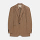 The Brown Virgin Wool Bern Blazer by Turnbull & Asser features notch lapels, two front patch pockets, a chest pocket, buttoned cuffs, and two buttons, shown over a beige collared shirt against a white background.