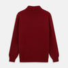 View 3 of product The Russet Cashmere Roll Neck Clark Jumper by Turnbull & Asser is a red, long-sleeve winter knit with ribbed cuffs, hem, and neckline, shown laid flat on a white background.