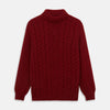 View 1 of product The Russet Cashmere Roll Neck Clark Jumper by Turnbull & Asser is a red, long-sleeve winter knit with ribbed cuffs, hem, and neckline, shown laid flat on a white background.