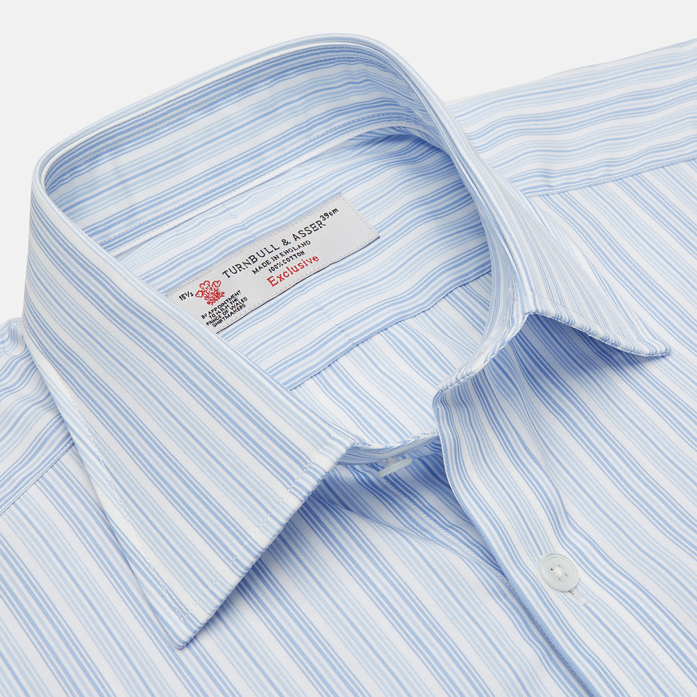 The Turnbull & Asser Blue & White Stripe Poplin Cotton Regular Fit Shirt features a T&A collar, double cuffs, and vertical stripes, showcased against a plain white background.
