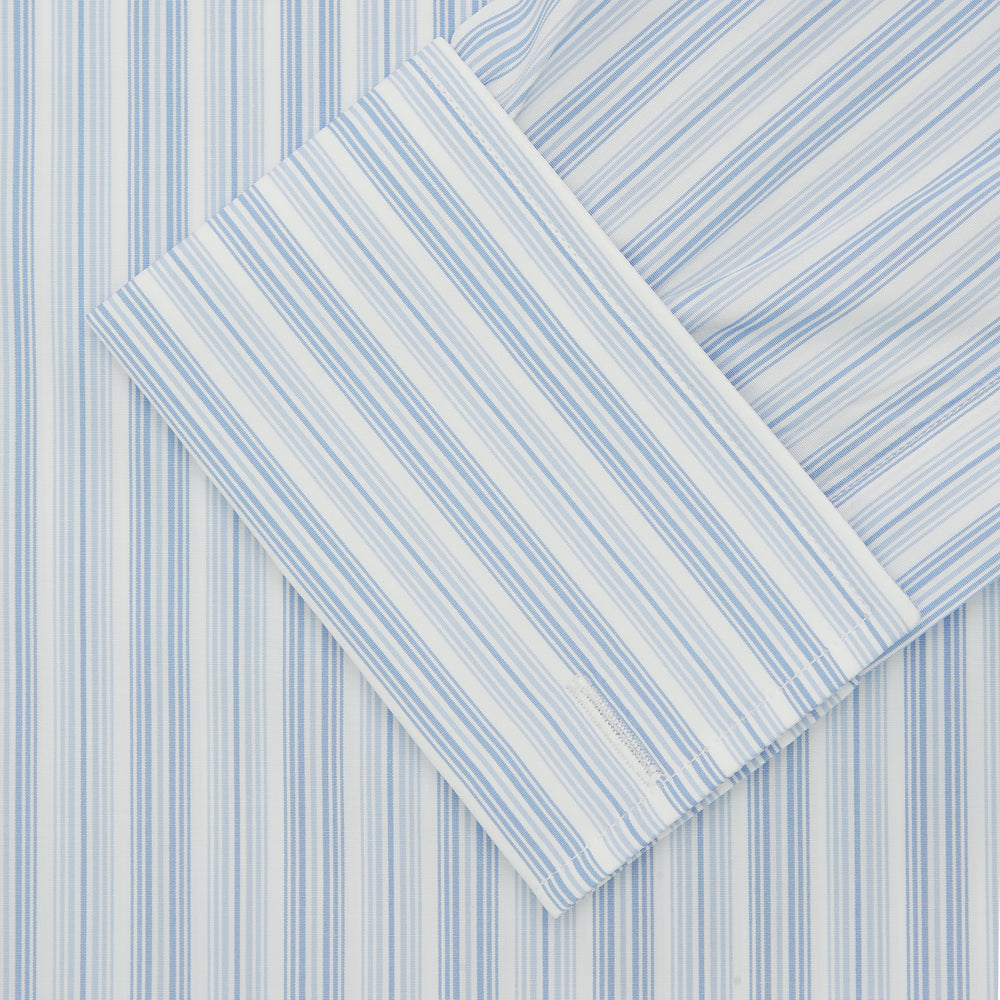 The Turnbull & Asser Blue & White Stripe Poplin Cotton Regular Fit Shirt features a T&A collar, double cuffs, and vertical stripes, showcased against a plain white background.