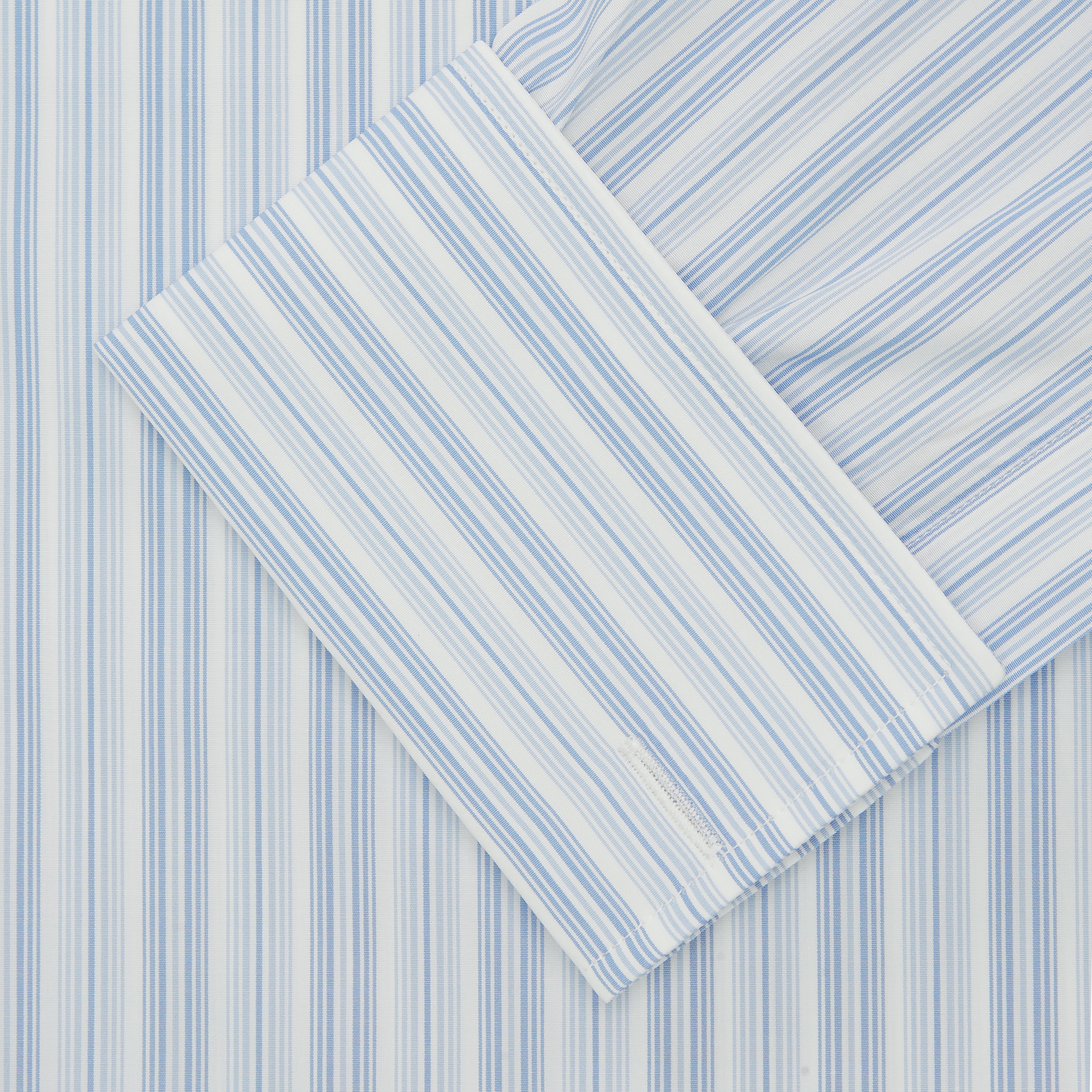 View 2 of product The Turnbull & Asser Blue & White Stripe Poplin Cotton Regular Fit Shirt features a T&A collar, double cuffs, and vertical stripes, showcased against a plain white background.