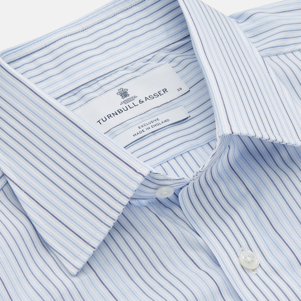 Turnbull & Asser’s Blue and White Stripe Twill Cotton Regular Fit Shirt features a T&A collar, double cuffs, and classic stripes, shown laid flat on a white background.