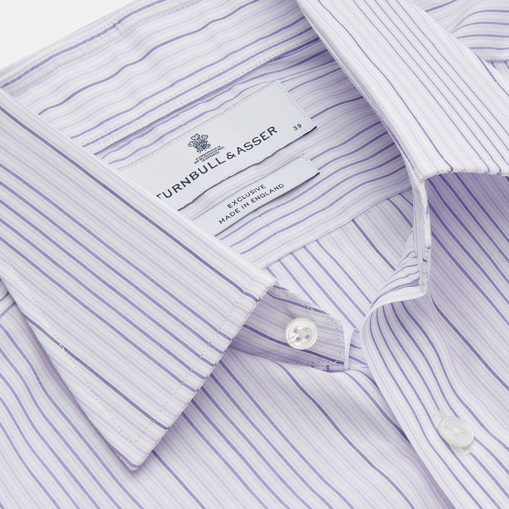The Turnbull & Asser Purple and White Stripe Twill Cotton Regular Fit Shirt features a T&A collar, double cuffs, and thin vertical stripes, displayed against a white background.