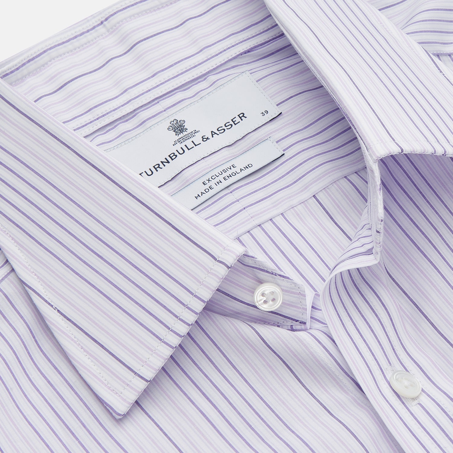 View 2 of product The Turnbull & Asser Purple and White Stripe Twill Cotton Regular Fit Shirt features a T&A collar, double cuffs, and thin vertical stripes, displayed against a white background.