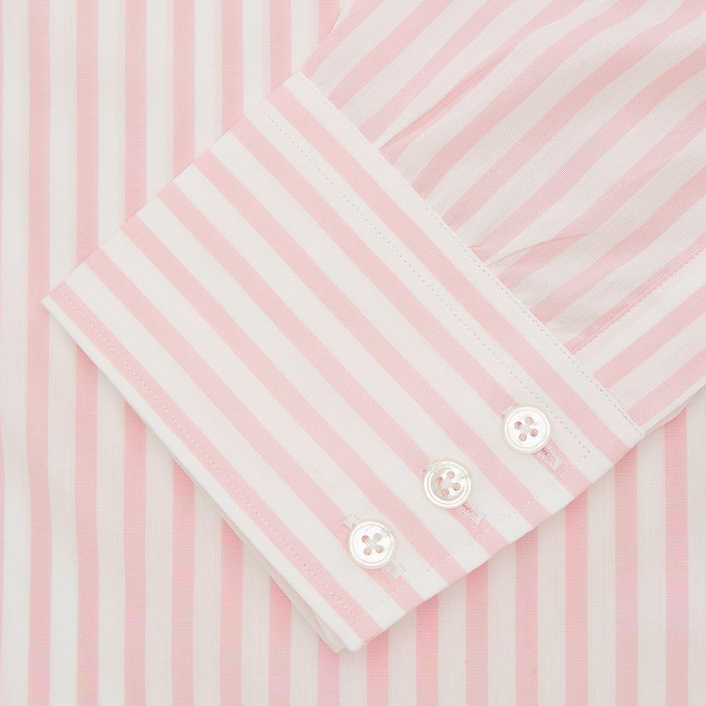 The Turnbull & Asser Pink & White Candy Stripe Poplin Regular Fit Shirt features a T&A collar, 3-button cuffs, and long sleeves, shown elegantly laid flat on a white background.