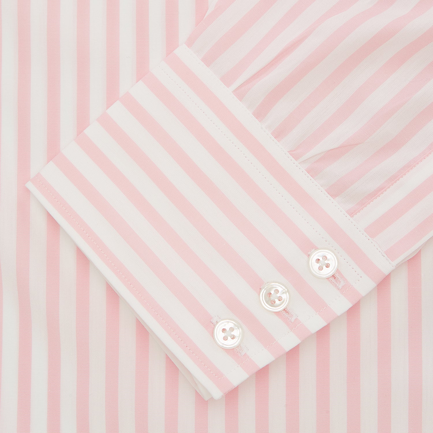 View 2 of product The Turnbull & Asser Pink & White Candy Stripe Poplin Regular Fit Shirt features a T&A collar, 3-button cuffs, and long sleeves, shown elegantly laid flat on a white background.