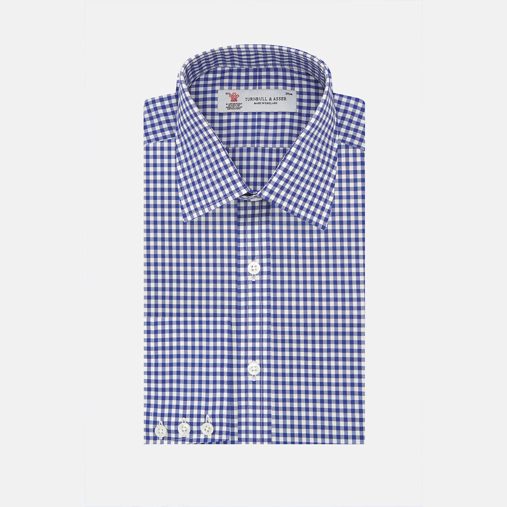 The Turnbull & Asser Navy & White Gingham Check Cotton Regular Fit Shirt features a T&A collar, 3-button cuffs, and is displayed neatly folded on a plain white background.