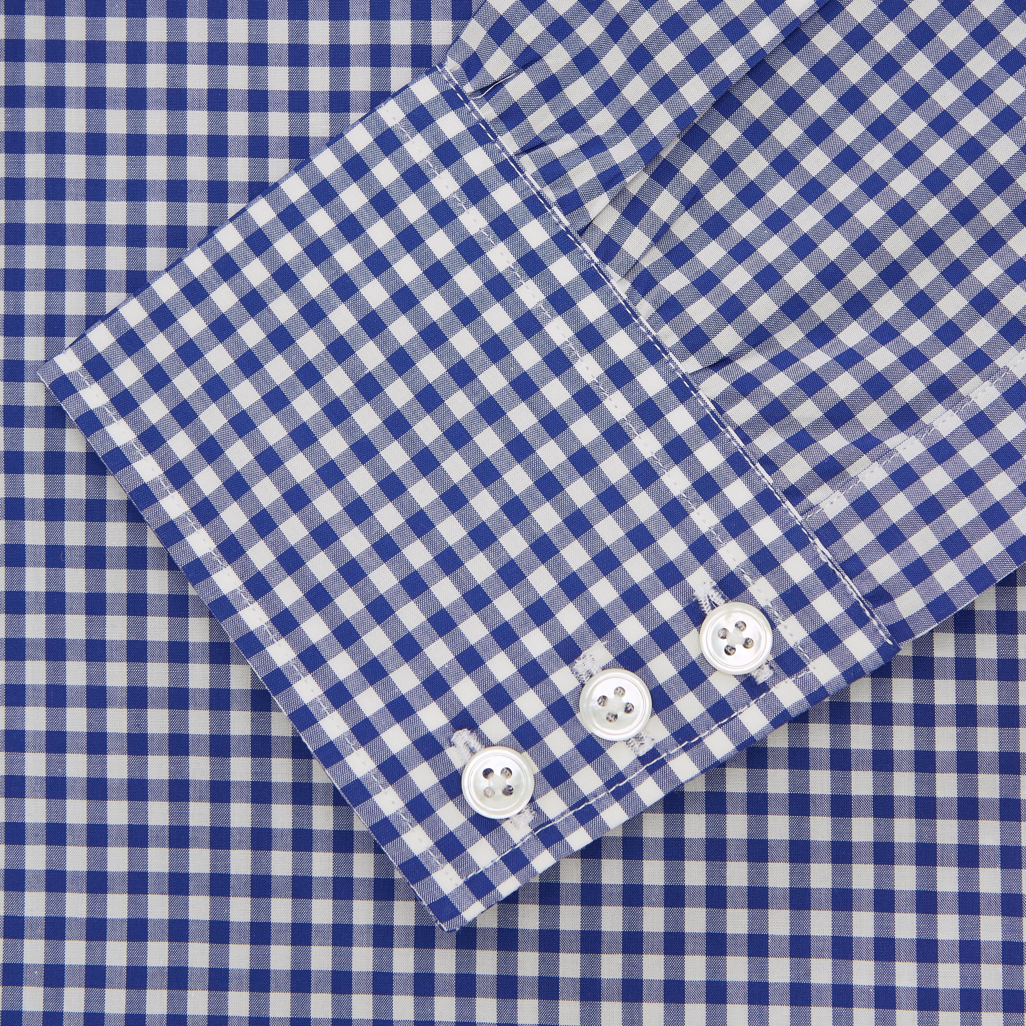 View 2 of product The Turnbull & Asser Navy & White Gingham Check Cotton Regular Fit Shirt features a T&A collar, 3-button cuffs, and is displayed neatly folded on a plain white background.