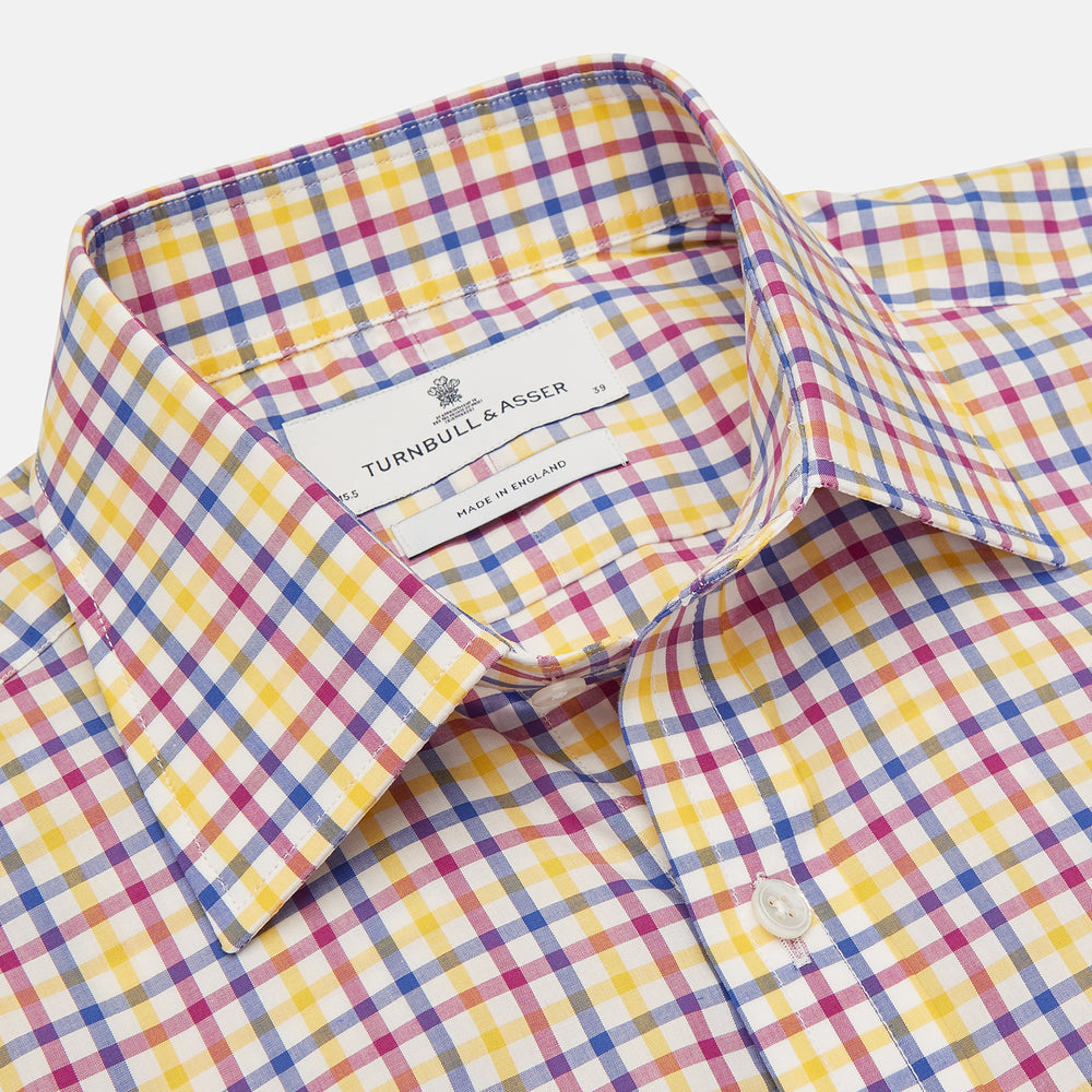 The Turnbull & Asser Blue, Yellow and Pink Check Shirt features a signature T&A collar, 3-button cuffs, and vibrant checks—an essential long-sleeve button-down for any men's wardrobe.